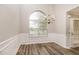 Dining room with new wood floors and a modern chandelier beneath a large window at 155 Oak Terrace Dr, Covington, GA 30016