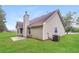 Back exterior of home with well-maintained lawn and beige siding at 155 Oak Terrace Dr, Covington, GA 30016