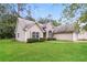 Well-manicured lawn surrounds this lovely home with neutral siding at 155 Oak Terrace Dr, Covington, GA 30016