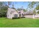 Inviting home featuring a spacious front yard, charming curb appeal, and a side-entry two-car garage at 155 Oak Terrace Dr, Covington, GA 30016