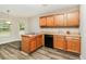 Well-lit kitchen features wood cabinets, laminate countertops and stainless-steel double sink and dishwasher at 155 Oak Terrace Dr, Covington, GA 30016