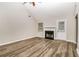 Bright living room featuring wood floors, a fireplace, and a vaulted ceiling at 155 Oak Terrace Dr, Covington, GA 30016