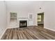 Inviting living room with a fireplace, neutral paint, and new wood floors at 155 Oak Terrace Dr, Covington, GA 30016