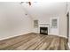 Bright living room featuring a fireplace, new floors and an exit door at 155 Oak Terrace Dr, Covington, GA 30016
