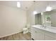 Bright bathroom featuring a modern vanity, sleek fixtures, a toilet, and stylish wood-look flooring at 2012 Elm Grove Ln, Hampton, GA 30228
