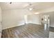 Open-concept living room with vaulted ceiling, hardwood floors, and views into the kitchen and hallways at 2012 Elm Grove Ln, Hampton, GA 30228