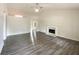 Open living room with hardwood floors, vaulted ceilings, a fireplace, and plenty of natural light at 2012 Elm Grove Ln, Hampton, GA 30228