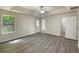 Spacious primary bedroom featuring a tray ceiling, ceiling fan, and ensuite bathroom at 2012 Elm Grove Ln, Hampton, GA 30228