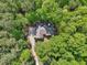 Aerial view of single Gathering home surrounded by dense trees providing plenty of privacy at 318 Dogwood Trce, Mcdonough, GA 30252