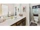 Bathroom featuring a large mirror, dark wood vanity, and shower/toilet combo at 318 Dogwood Trce, Mcdonough, GA 30252