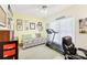 Bedroom with an office space that features natural lighting, a treadmill, and cozy seating at 318 Dogwood Trce, Mcdonough, GA 30252