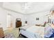 Bright bedroom features a tray ceiling, ceiling fan, and a comfortable bed at 318 Dogwood Trce, Mcdonough, GA 30252