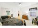 Bedroom featuring a bed with patterned bedding, mirrored closet, and ceiling fan at 318 Dogwood Trce, Mcdonough, GA 30252