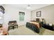 Bedroom featuring a window, ceiling fan, and bed with black and orange patterned bedding at 318 Dogwood Trce, Mcdonough, GA 30252