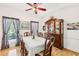 Charming dining room featuring hardwood floors, natural light, and a decorative china cabinet at 318 Dogwood Trce, Mcdonough, GA 30252