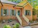 Charming brick home featuring a welcoming entrance with decorative door, shutters, and landscaped front yard at 318 Dogwood Trce, Mcdonough, GA 30252