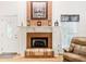 Close-up of fireplace featuring brick surround and traditional mantel at 318 Dogwood Trce, Mcdonough, GA 30252