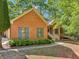 Charming brick home featuring blue shutters, well-manicured landscaping, and inviting walkway at 318 Dogwood Trce, Mcdonough, GA 30252