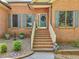 Charming brick home with steps up to the doorway with shutters and a landscaped front yard at 318 Dogwood Trce, Mcdonough, GA 30252