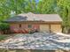 Side view of home featuring brick exterior, two-car garage and large concrete driveway at 318 Dogwood Trce, Mcdonough, GA 30252