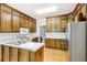 Well-lit kitchen featuring wood cabinetry, stainless steel appliances, and neutral countertops at 318 Dogwood Trce, Mcdonough, GA 30252