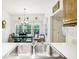 Bright kitchen view showcasing the stainless sink and adjacent view to the dining nook at 318 Dogwood Trce, Mcdonough, GA 30252