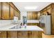 Classic kitchen with wood cabinets, stainless steel refrigerator, and light countertops at 318 Dogwood Trce, Mcdonough, GA 30252