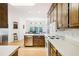 Spacious kitchen showcasing stainless steel appliances and wood cabinets with a dining area at 318 Dogwood Trce, Mcdonough, GA 30252