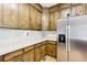 Functional kitchen featuring ample wood cabinet storage, light countertops and a stainless steel refrigerator at 318 Dogwood Trce, Mcdonough, GA 30252