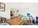 Open office area with hardwood floors, desk, and a view into the dining room at 318 Dogwood Trce, Mcdonough, GA 30252