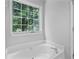 Relaxing bathroom boasts a large tub and a view of mature trees at 3315 Brookfield Dr, Austell, GA 30106
