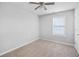 Bedroom with carpet, a window, ceiling fan, and door to the hallway at 3315 Brookfield Dr, Austell, GA 30106