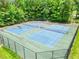 Community Tennis Courts with netting and surrounded by trees at 3315 Brookfield Dr, Austell, GA 30106
