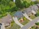 An aerial view displays this home with mature landscaping and long driveway nestled in a beautiful neighborhood at 4190 Madison Dr, Cumming, GA 30040