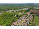 Aerial view captures a community nestled among green spaces, showcasing homes with well-kept landscaping and lawns at 4190 Madison Dr, Cumming, GA 30040