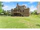 The back exterior of the home shows a beautiful lawn, a patio, a deck, and a screened-in porch at 4190 Madison Dr, Cumming, GA 30040