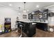 Basement wet bar area with seating and dark cabinetry, creating an entertainment destination at 4190 Madison Dr, Cumming, GA 30040