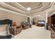 Finished basement with a seating area, gym equipment, and access to the bedroom at 4190 Madison Dr, Cumming, GA 30040