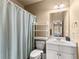 Bright bathroom featuring a shower, toilet, and single sink at 4190 Madison Dr, Cumming, GA 30040