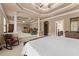 Expansive main bedroom with tray ceiling, exercise equipment, and access to the bathroom at 4190 Madison Dr, Cumming, GA 30040