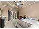 Spacious bedroom featuring neutral paint, tray ceiling, and ensuite at 4190 Madison Dr, Cumming, GA 30040