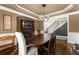 Elegant dining room featuring a chandelier, dark wood table, and classic staircase in the background at 4190 Madison Dr, Cumming, GA 30040