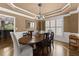 Elegant dining room with hardwood floors, wainscoting, and abundant natural light at 4190 Madison Dr, Cumming, GA 30040