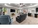 Spacious living room with tv and a gray reclining sofa, which makes it a great place to relax at 4190 Madison Dr, Cumming, GA 30040