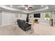 Living room with tray ceiling and a gray reclining sofa near a window for natural light at 4190 Madison Dr, Cumming, GA 30040