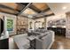 Open-concept living room featuring a fireplace, stone pillars, and views into the kitchen at 4190 Madison Dr, Cumming, GA 30040