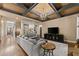 Spacious living room with coffered ceiling, built-in shelving, hardwood floors, and comfortable seating at 4190 Madison Dr, Cumming, GA 30040