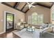 Bright living room with vaulted ceilings, plantation shutters, and a view of the outdoor patio at 4190 Madison Dr, Cumming, GA 30040
