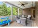 Inviting screened porch with seating, ceiling fan, and lush greenery views at 4190 Madison Dr, Cumming, GA 30040