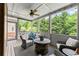 Relaxing screened porch with comfortable seating, ceiling fan, and views of the backyard at 4190 Madison Dr, Cumming, GA 30040